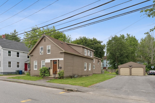26 Cross St, Westbrook, ME 04092 - view of front facade with a detached garage, an outdoor structure, and a front yard