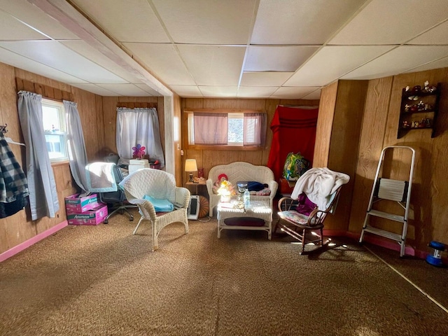 322 Katahdin Ave, Millinocket, ME 04462 - sitting room with wood walls, a paneled ceiling, and carpet floors
