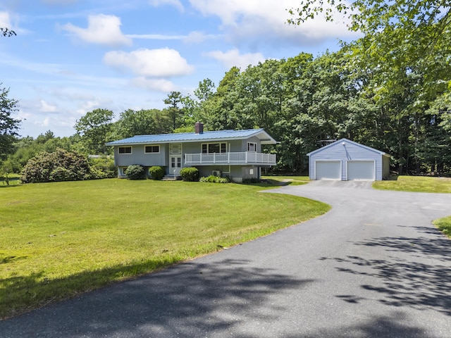 232 Augusta Rd, Topsham, ME 04086 - raised ranch featuring a detached garage, an outdoor structure, a front yard, a metal roof, and a chimney