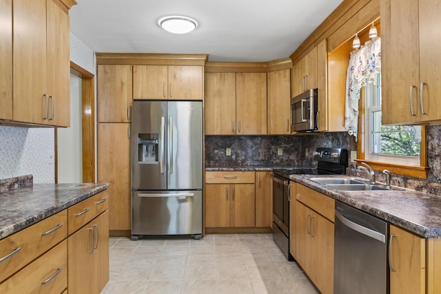 232 Augusta Rd, Topsham, ME 04086 - kitchen featuring appliances with stainless steel finishes, dark countertops, tasteful backsplash, and brown cabinetry