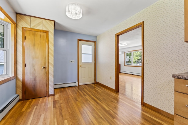 232 Augusta Rd, Topsham, ME 04086 - unfurnished room featuring a baseboard heating unit, light wood-style flooring, and wallpapered walls