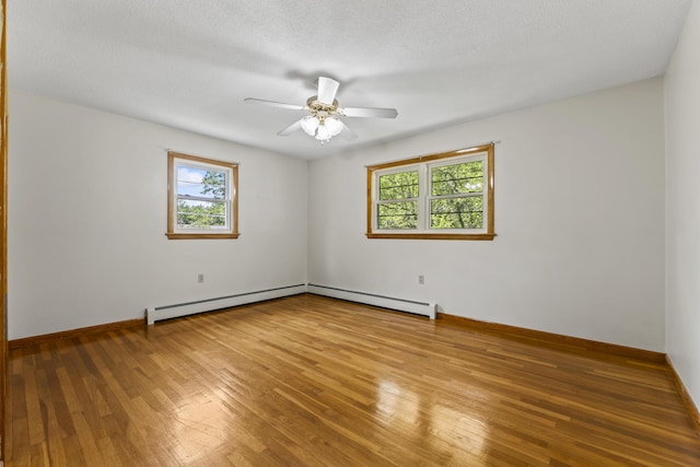 232 Augusta Rd, Topsham, ME 04086 - spare room with plenty of natural light, hardwood / wood-style flooring, ceiling fan, and a baseboard radiator