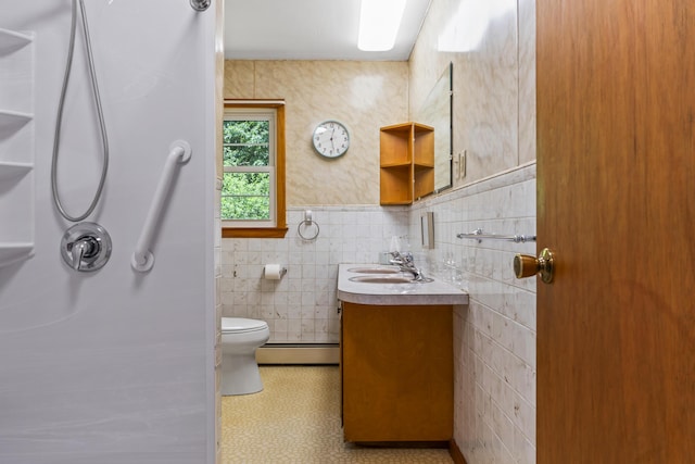 232 Augusta Rd, Topsham, ME 04086 - bathroom featuring a baseboard heating unit, tile walls, vanity, a shower, and tile patterned floors
