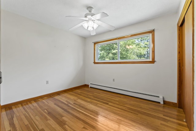 232 Augusta Rd, Topsham, ME 04086 - unfurnished bedroom with a baseboard heating unit, a closet, light wood-type flooring, and a ceiling fan