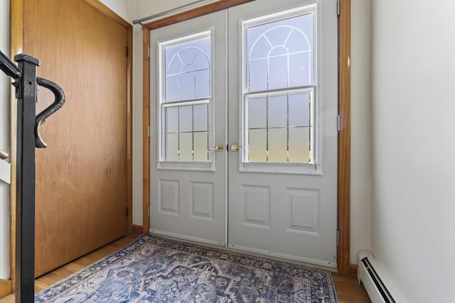 232 Augusta Rd, Topsham, ME 04086 - doorway featuring a baseboard heating unit, french doors, and light wood-style flooring