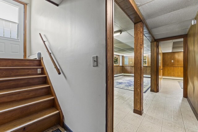 232 Augusta Rd, Topsham, ME 04086 - stairway featuring wooden walls and a baseboard heating unit
