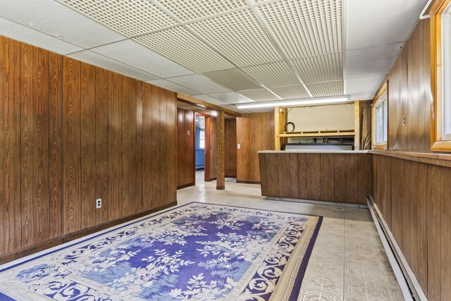 232 Augusta Rd, Topsham, ME 04086 - bar area with baseboard heating, wood walls, and a paneled ceiling