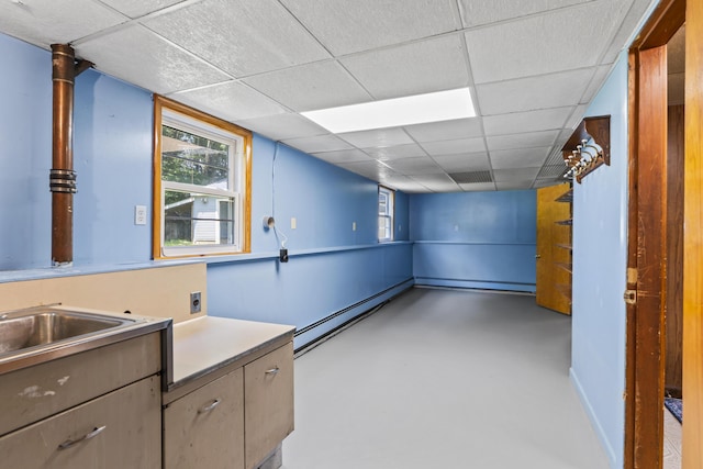 232 Augusta Rd, Topsham, ME 04086 - below grade area with a baseboard heating unit and a paneled ceiling