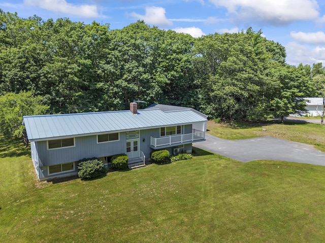 232 Augusta Rd, Topsham, ME 04086 - raised ranch with a front yard, a chimney, a metal roof, and a porch