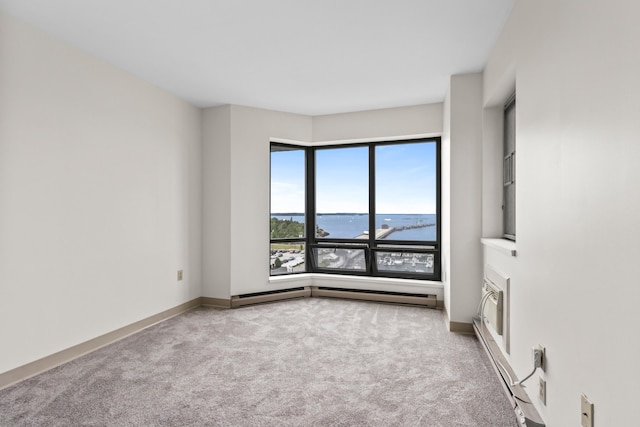 148 Breakwater Dr Unit 808, South Portland, ME 04106 - carpeted spare room with a water view, baseboard heating, and a baseboard heating unit
