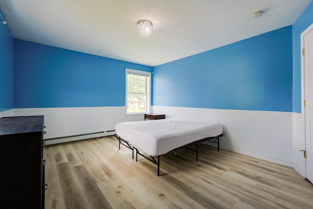 18 Wilson Dr, Westbrook, ME 04092 - bedroom with baseboard heating, wainscoting, and wood finished floors