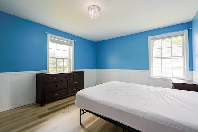 18 Wilson Dr, Westbrook, ME 04092 - bedroom with wainscoting, multiple windows, and light wood-style floors
