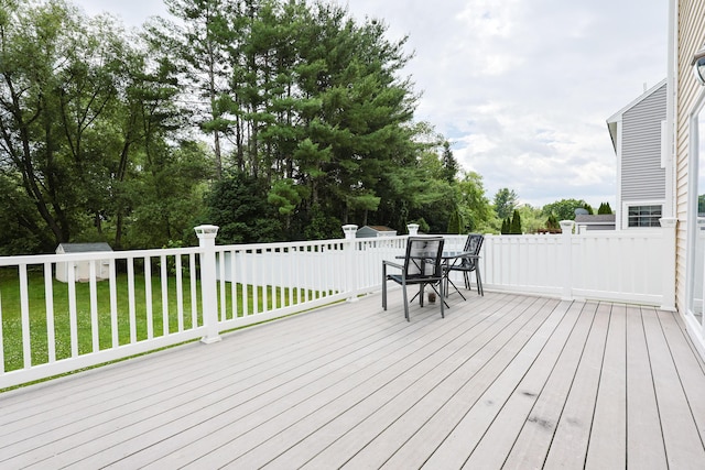 18 Wilson Dr, Westbrook, ME 04092 - wooden terrace with outdoor dining area, a lawn, and view of scattered trees