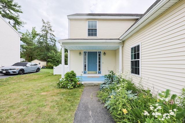 18 Wilson Dr, Westbrook, ME 04092 - view of exterior entry featuring a yard and a porch