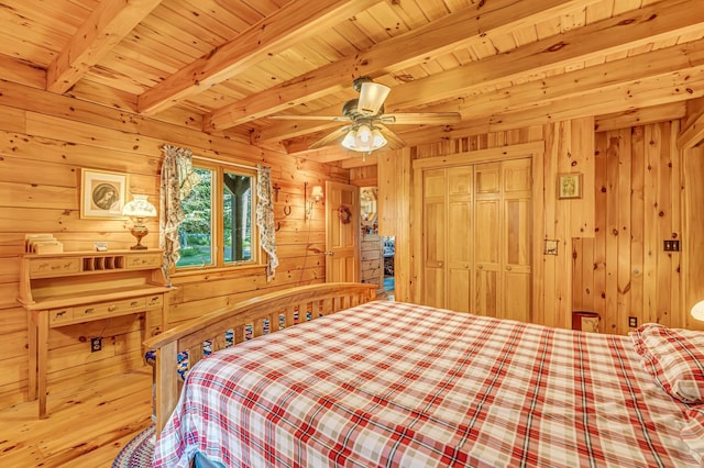 642 Mingo Loop Rd, Rangeley, ME 04970 - bedroom with wood walls, wood finished floors, a wood ceiling with exposed beams, a closet, and ceiling fan