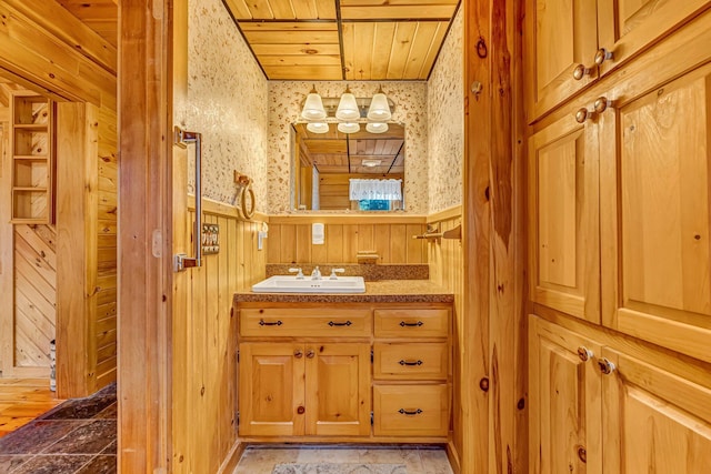642 Mingo Loop Rd, Rangeley, ME 04970 - bathroom with a wainscoted wall, vanity, wood ceiling, and wood walls