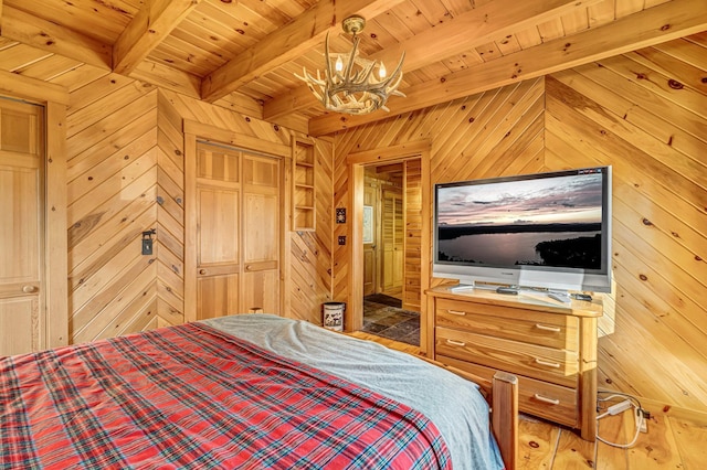 642 Mingo Loop Rd, Rangeley, ME 04970 - bedroom featuring wooden walls, a chandelier, a wood ceiling with exposed beams, and wood finished floors