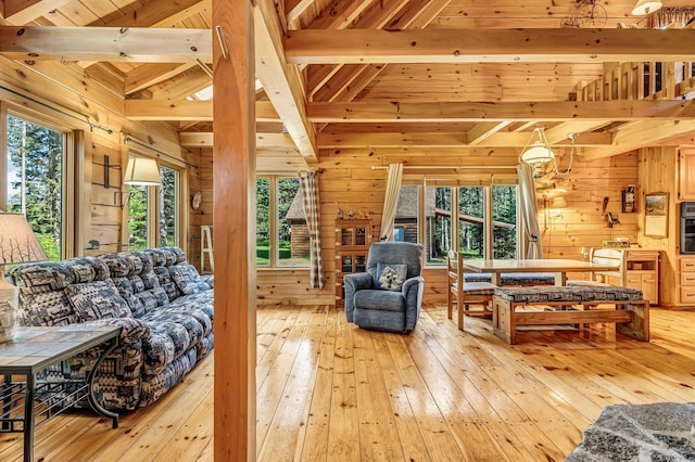 642 Mingo Loop Rd, Rangeley, ME 04970 - living room with wooden walls, light wood-style floors, healthy amount of natural light, and wood ceiling