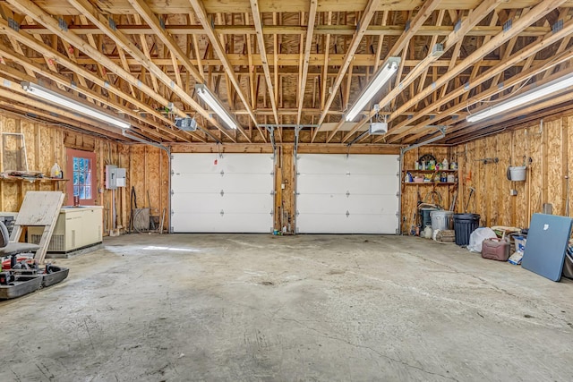 642 Mingo Loop Rd, Rangeley, ME 04970 - garage with a garage door opener and electric panel