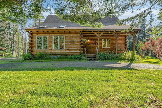 642 Mingo Loop Rd, Rangeley, ME 04970 - view of front of house featuring log siding, covered porch, roof with shingles, and a front yard