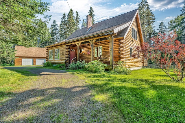 642 Mingo Loop Rd, Rangeley, ME 04970 - log-style house with a porch, a chimney, a front yard, log siding, and a detached garage