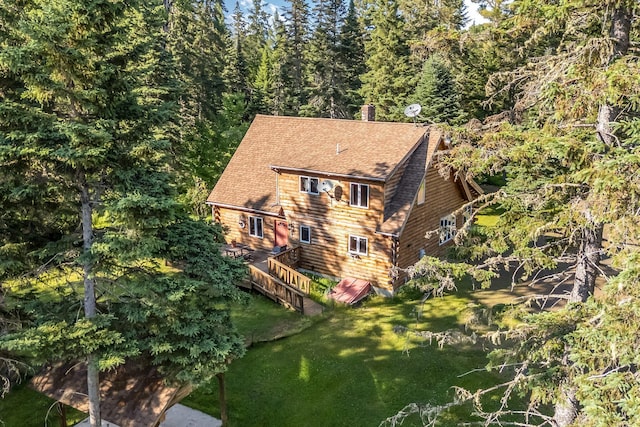 642 Mingo Loop Rd, Rangeley, ME 04970 - view of front of house with roof with shingles, a front lawn, a chimney, and a view of trees