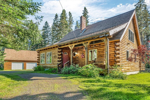 642 Mingo Loop Rd, Rangeley, ME 04970 - log-style house with log siding, a chimney, covered porch, a front yard, and a garage