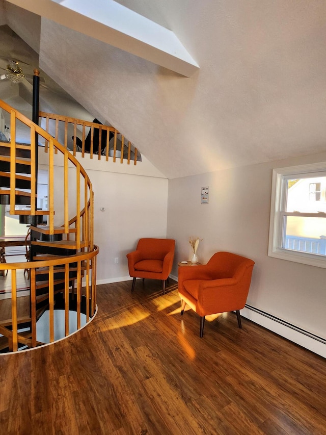 69 Scott Dr, Monmouth, ME 04259 - living area with wood finished floors, vaulted ceiling, stairs, a ceiling fan, and baseboard heating