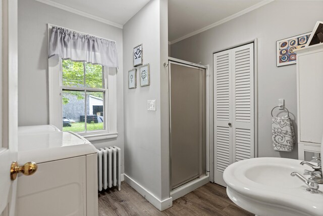 15 Winter St, Topsham, ME 04086 - bathroom featuring radiator heating unit, a closet, wood finished floors, a shower stall, and washer / dryer