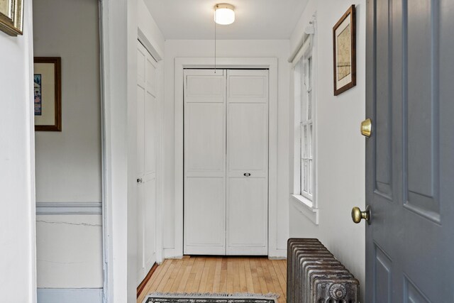 15 Winter St, Topsham, ME 04086 - corridor with radiator heating unit and light wood-style flooring