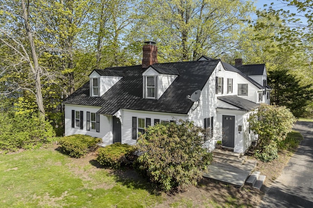 15 Winter St, Topsham, ME 04086 - cape cod home featuring a chimney, a front yard, and view of scattered trees