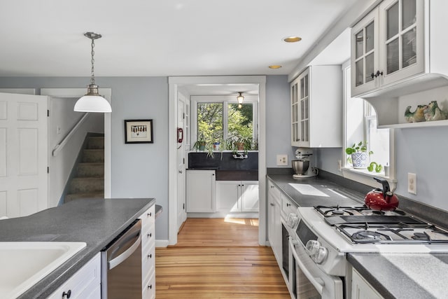 15 Winter St, Topsham, ME 04086 - kitchen featuring gas range, dishwasher, dark countertops, light wood-type flooring, and hanging light fixtures