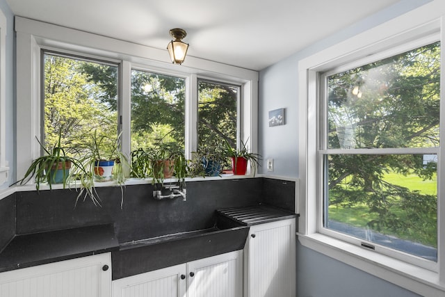 15 Winter St, Topsham, ME 04086 - kitchen with dark countertops, healthy amount of natural light, and white cabinetry