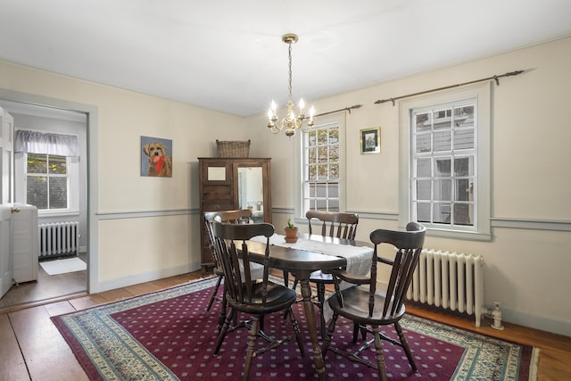 15 Winter St, Topsham, ME 04086 - dining space with radiator, a chandelier, and healthy amount of natural light