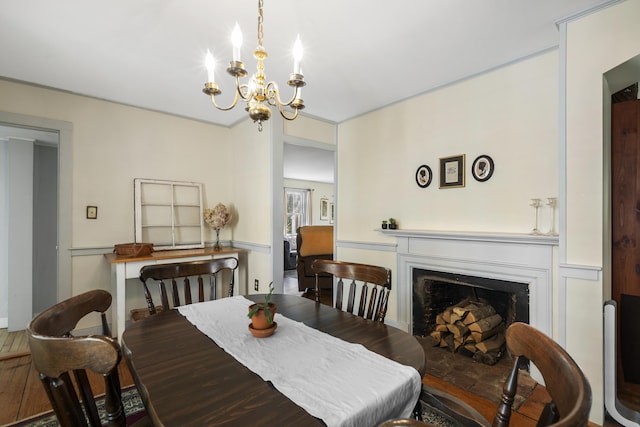 15 Winter St, Topsham, ME 04086 - dining room featuring a chandelier, a fireplace, and a wainscoted wall