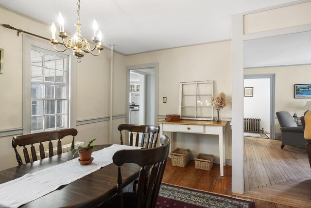 15 Winter St, Topsham, ME 04086 - dining space with radiator heating unit, a chandelier, wood-type flooring, and crown molding