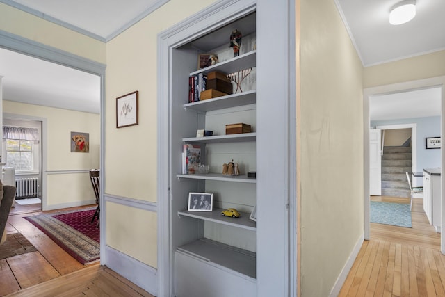 15 Winter St, Topsham, ME 04086 - hall featuring ornamental molding, hardwood / wood-style flooring, radiator heating unit, and stairs