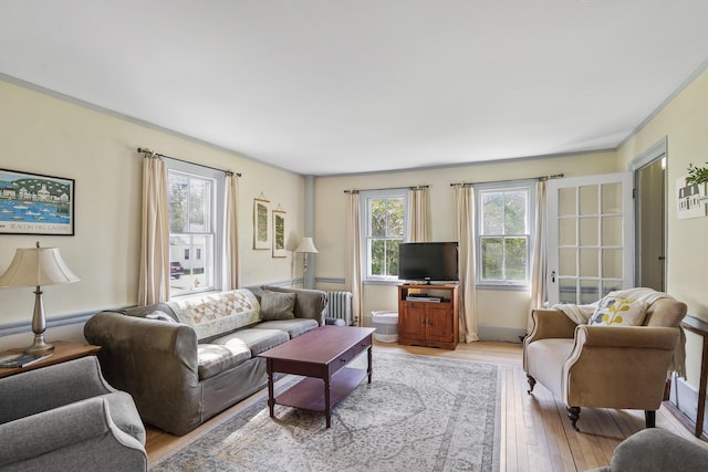 15 Winter St, Topsham, ME 04086 - living area with radiator heating unit and light wood-style flooring