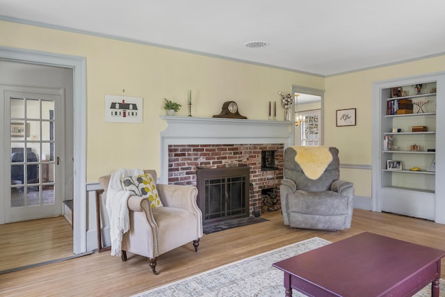 15 Winter St, Topsham, ME 04086 - living room with wood finished floors, built in shelves, and a brick fireplace