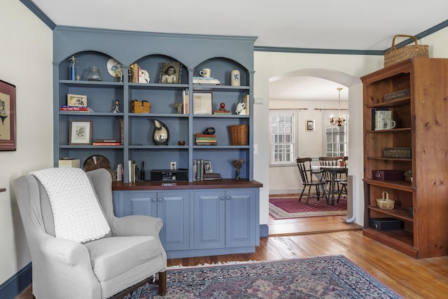 15 Winter St, Topsham, ME 04086 - living area featuring arched walkways, light wood-type flooring, a chandelier, and crown molding