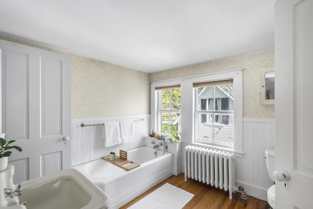 15 Winter St, Topsham, ME 04086 - full bathroom with radiator, wainscoting, a garden tub, wood finished floors, and wallpapered walls