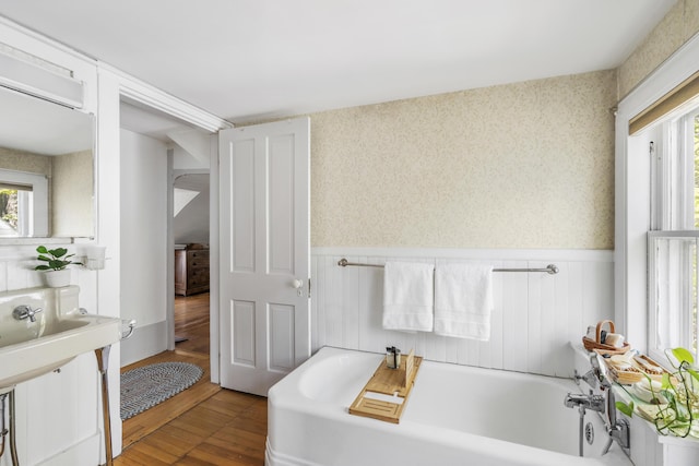 15 Winter St, Topsham, ME 04086 - bathroom with a garden tub, wainscoting, wood finished floors, and wallpapered walls