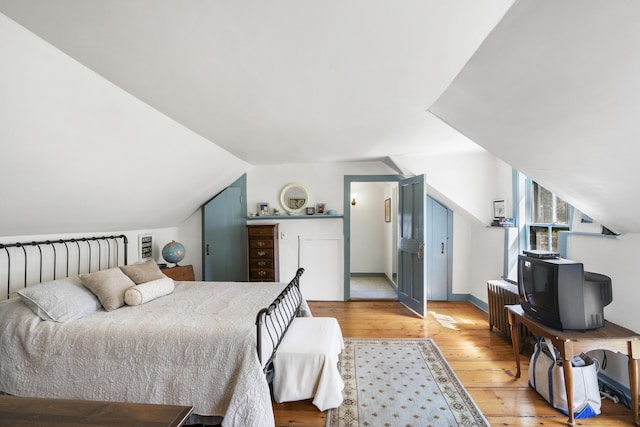15 Winter St, Topsham, ME 04086 - bedroom featuring light wood-style flooring, lofted ceiling, and radiator
