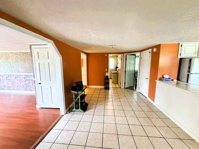 1039 Belfast Rd, Knox, ME 04986 - empty room with light tile patterned floors and wallpapered walls