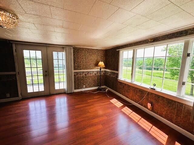 1039 Belfast Rd, Knox, ME 04986 - empty room featuring plenty of natural light and dark wood-type flooring