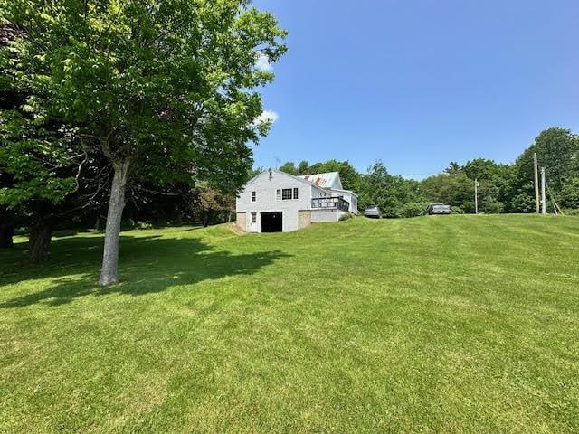 1039 Belfast Rd, Knox, ME 04986 - view of grassy yard featuring a garage