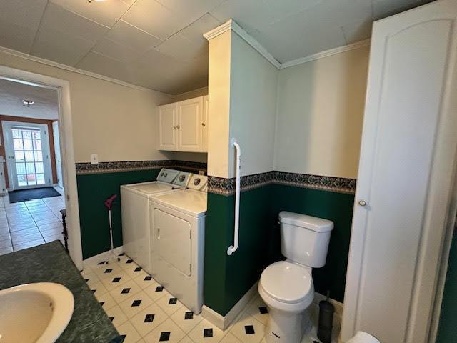 1039 Belfast Rd, Knox, ME 04986 - bathroom featuring washing machine and dryer, crown molding, a wainscoted wall, vanity, and tile patterned floors