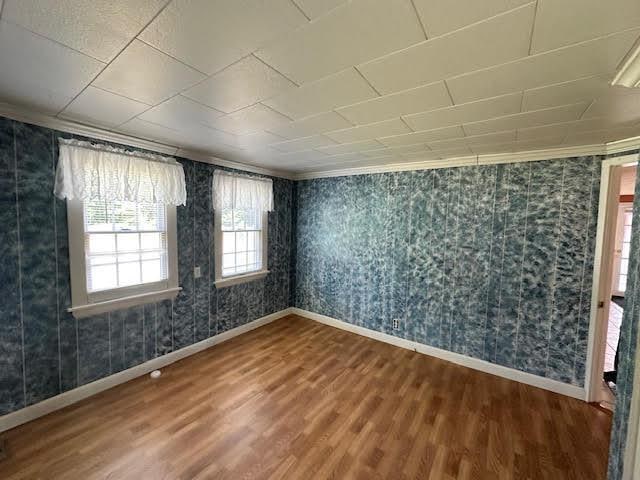 1039 Belfast Rd, Knox, ME 04986 - spare room featuring wood finished floors, crown molding, and wallpapered walls