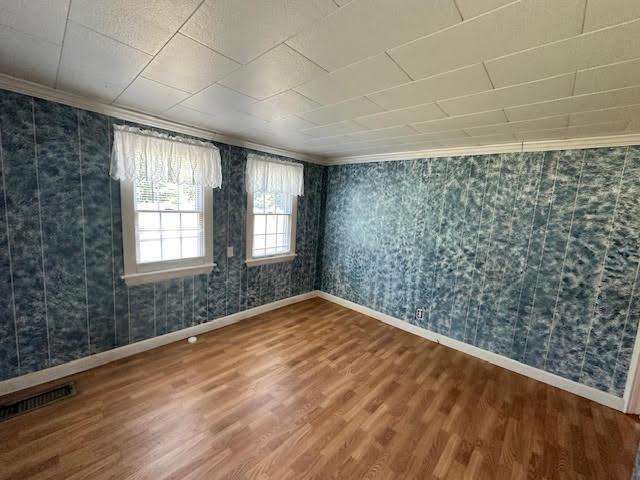1039 Belfast Rd, Knox, ME 04986 - empty room featuring ornamental molding, wood finished floors, and wallpapered walls