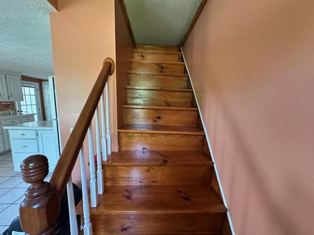 1039 Belfast Rd, Knox, ME 04986 - staircase featuring a textured ceiling